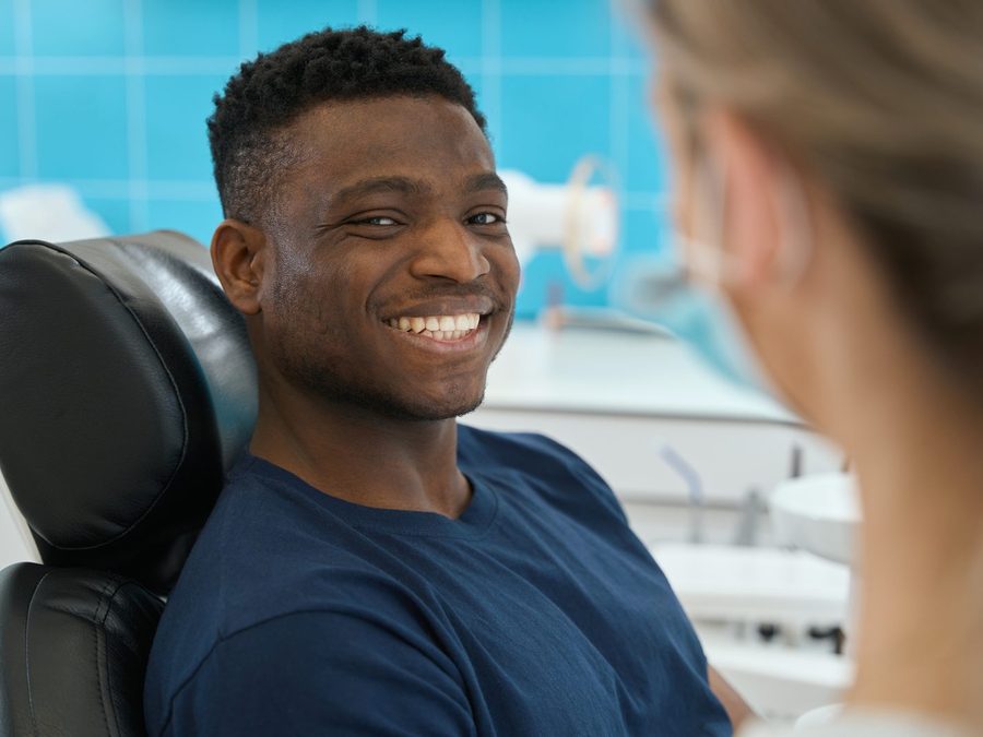Happy patient smiling in dental chair