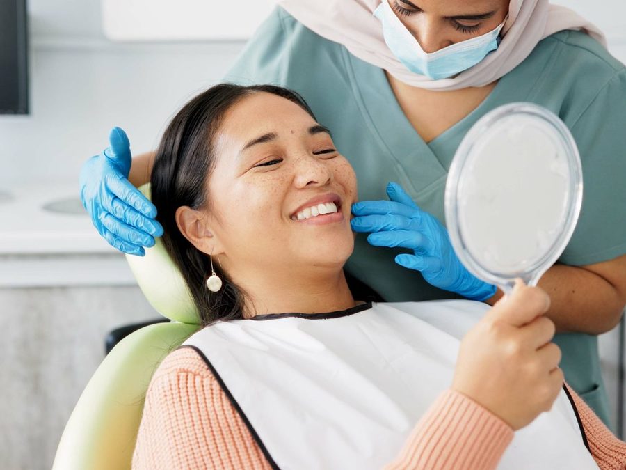Patient admiring her smile in a mirror
